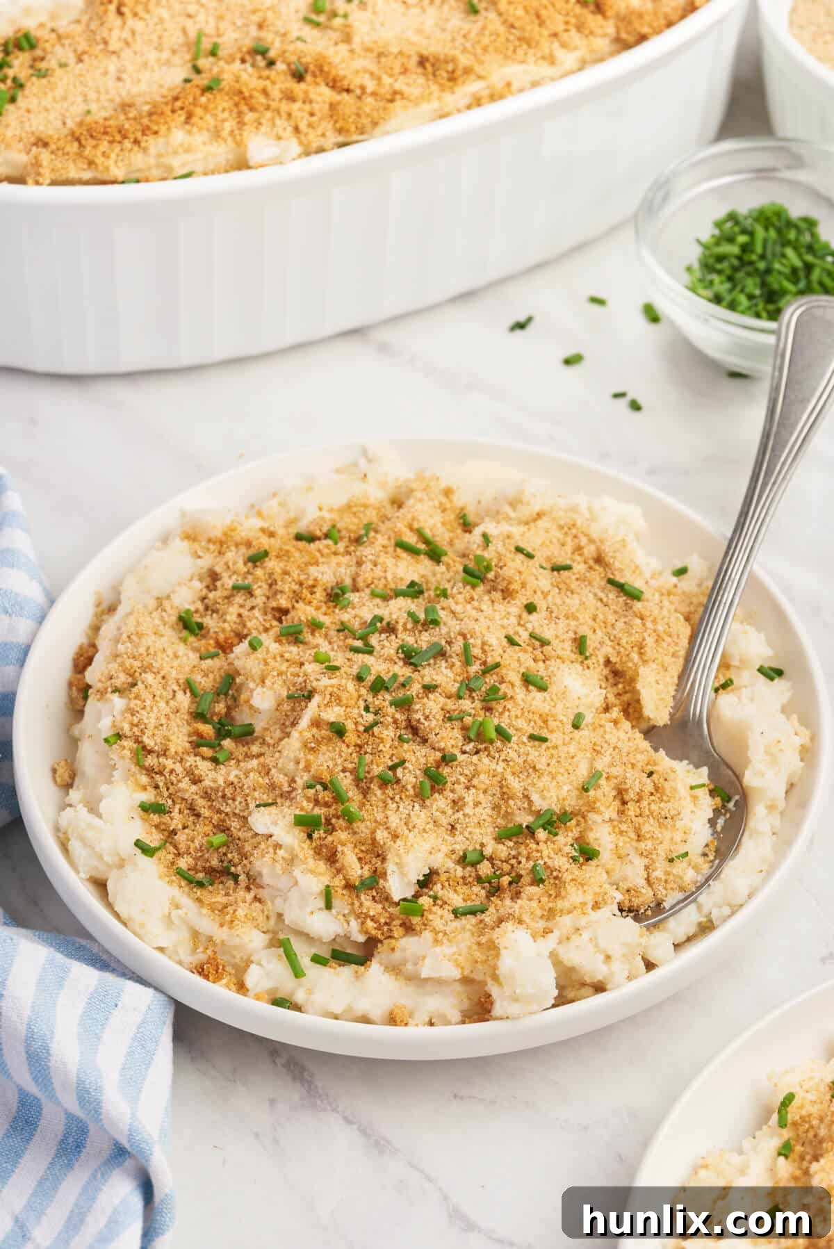 A plate of Swedish Potatoes with a fork.