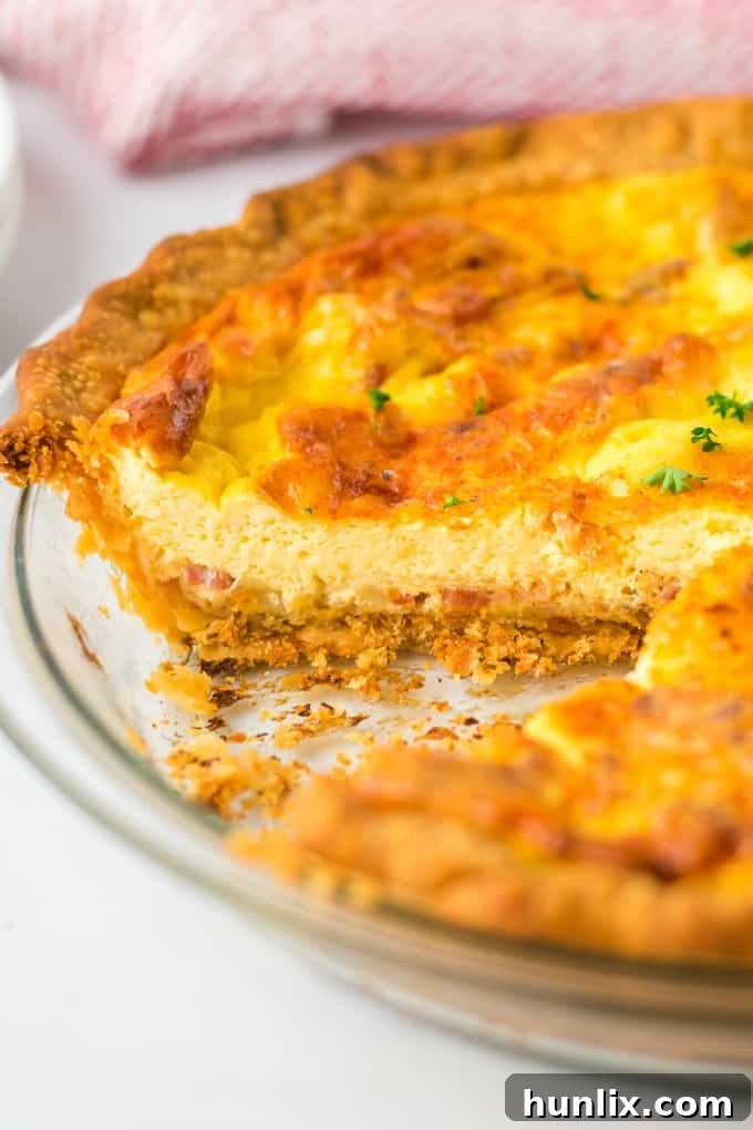 Close-up of a slice of Quiche Lorraine on a serving spatula