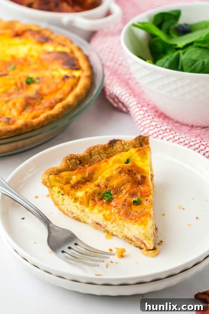 A whole Quiche Lorraine, ready to be served, on a wooden cutting board