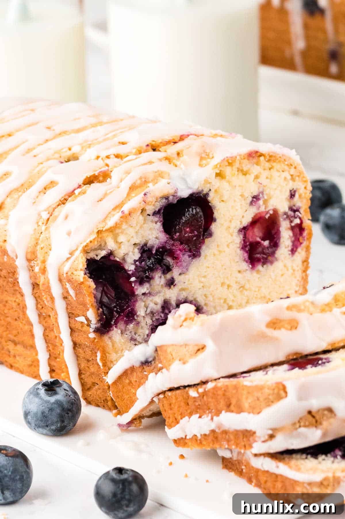 Blueberry Burst Loaf 8 A loaf of bread with slices cut.