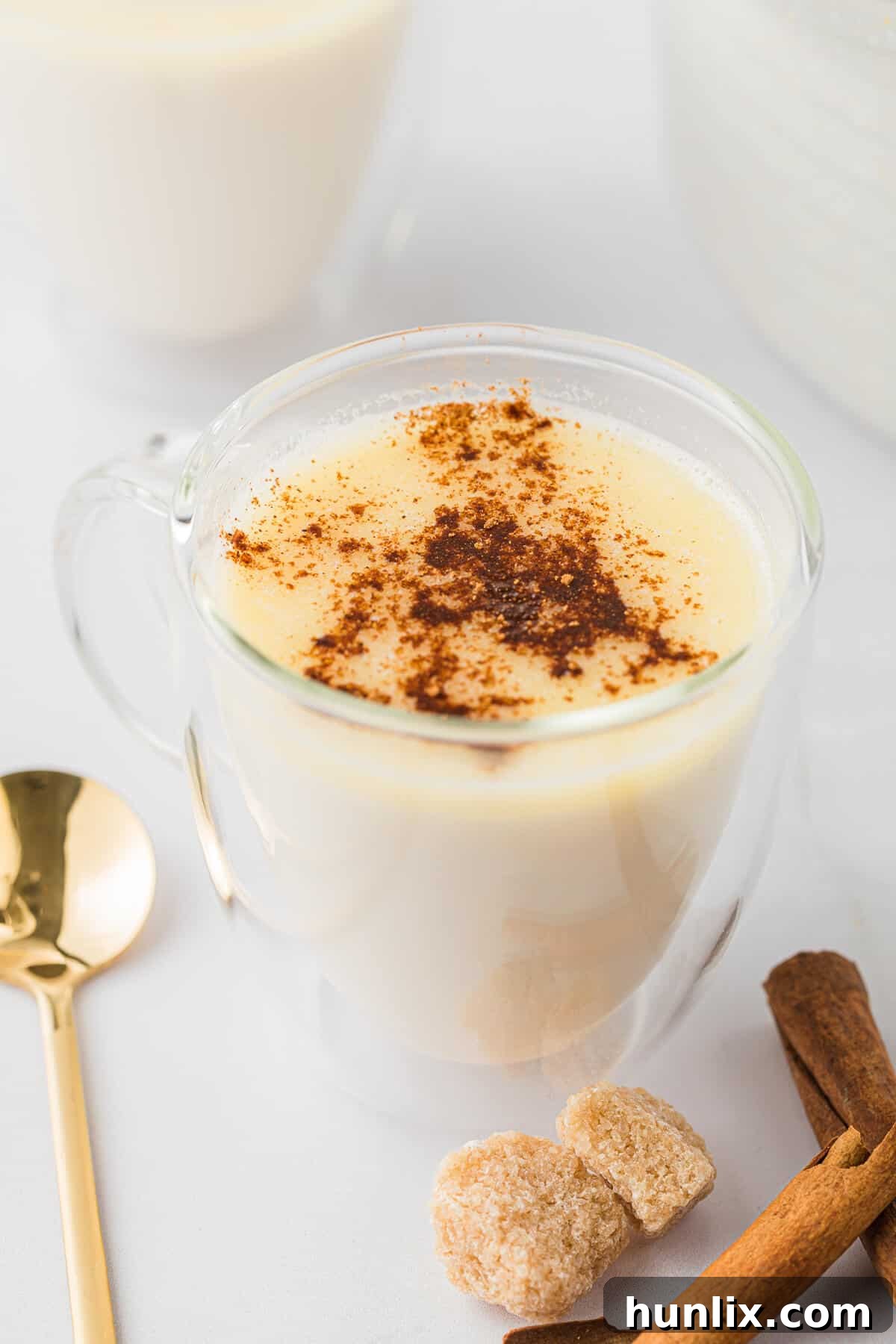 A butterscotch steamer served in an elegant clear glass mug, showcasing its creamy texture and rich color, ready to be enjoyed.