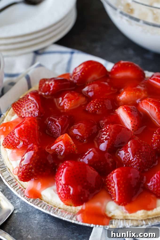 Strawberry Satin Pie - A beloved vintage summer pie that is worth the extra effort. Layers of toasted almonds, creamy and sweet vanilla filling and luscious strawberries enveloped in a shiny glaze make this dessert a huge hit.