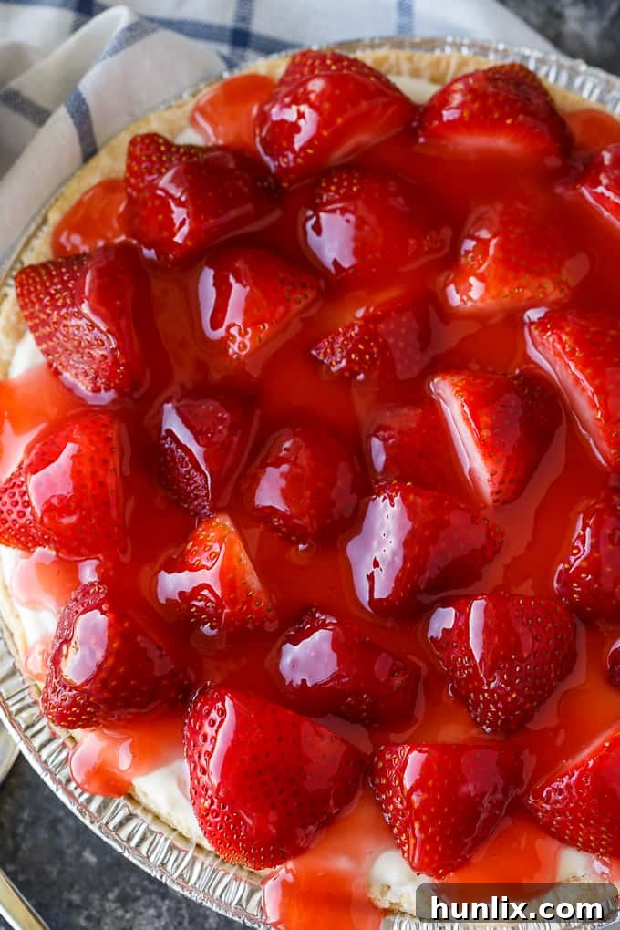 Strawberry Satin Pie - A beloved vintage summer pie that is worth the extra effort. Layers of toasted almonds, creamy and sweet vanilla filling and luscious strawberries enveloped in a shiny glaze make this dessert a huge hit.