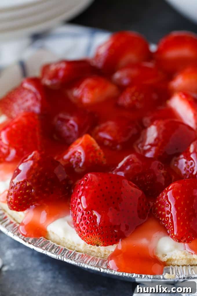 Strawberry Satin Pie - A beloved vintage summer pie that is worth the extra effort. Layers of toasted almonds, creamy and sweet vanilla filling and luscious strawberries enveloped in a shiny glaze make this dessert a huge hit.