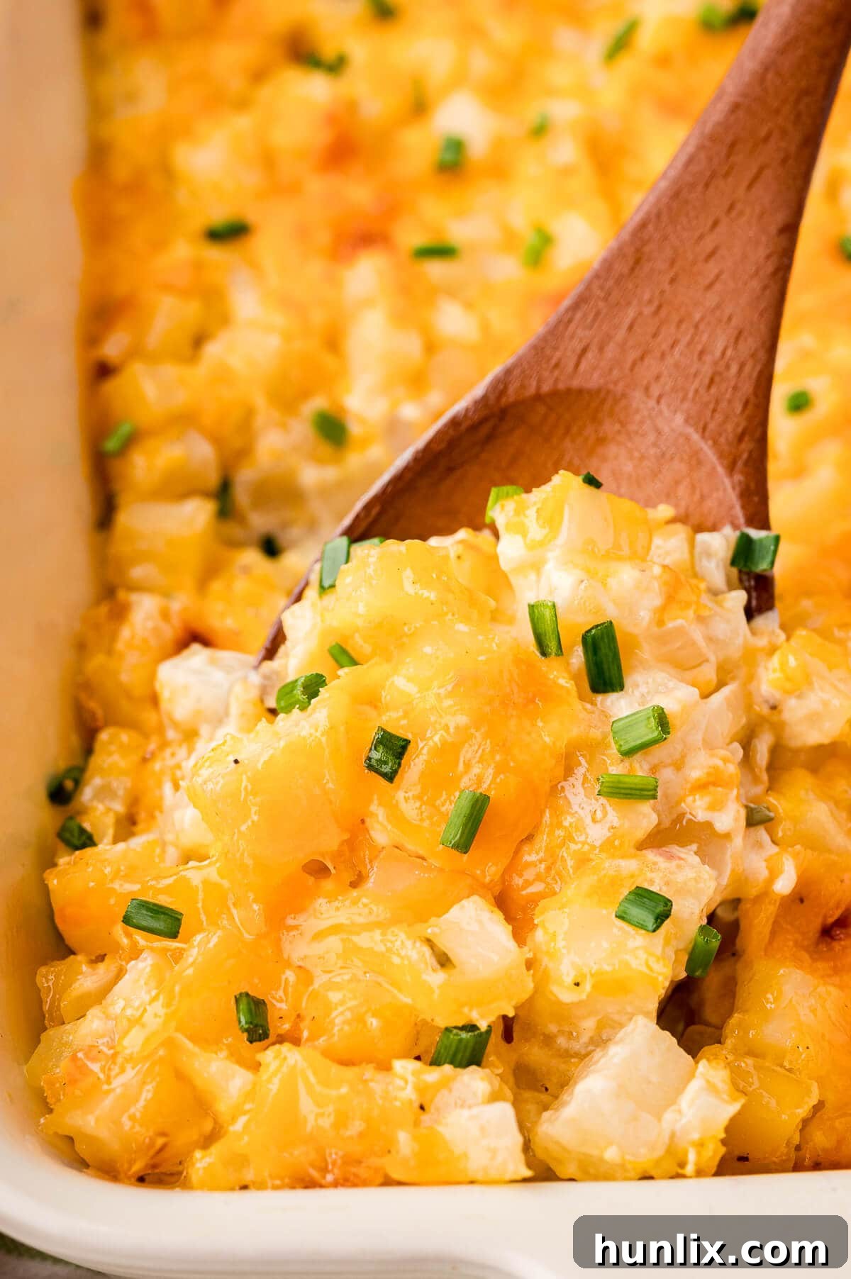 Party potatoes on a wooden spoon.