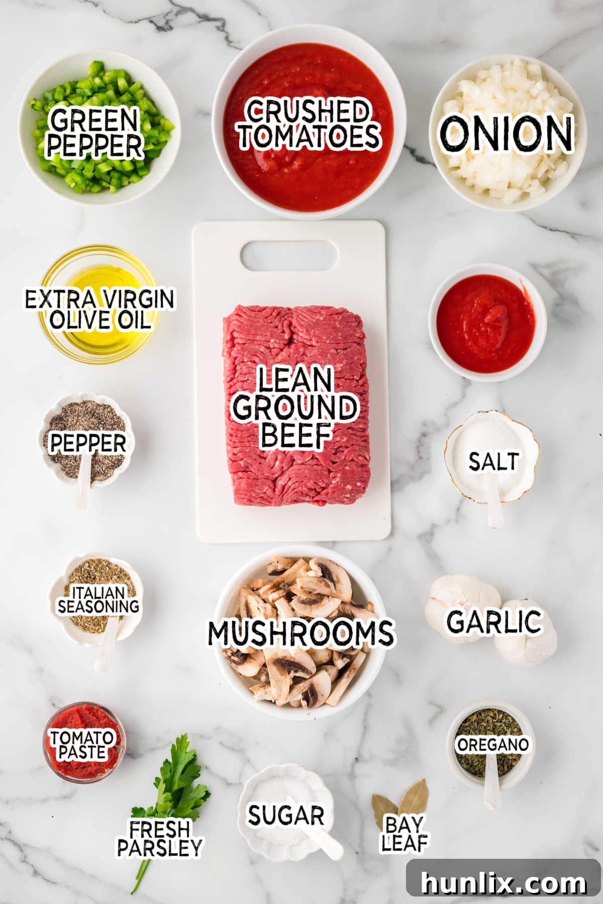 Mama's Perfect Pasta Sauce 3 All fresh ingredients for homemade spaghetti sauce laid out on a marble background.