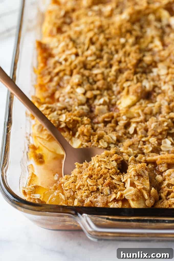 Apple Crisp - This simple old-fashioned dessert is baked with sweet and tart apples and topped with a brown sugar oat crumble. One of the best homemade fall desserts. Serve with vanilla ice cream for extra decadence.