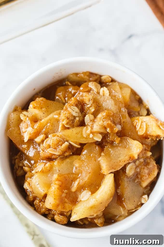 Apple Crisp - This simple old-fashioned dessert is baked with sweet and tart apples and topped with a brown sugar oat crumble. One of the best homemade fall desserts. Serve with vanilla ice cream for extra decadence.