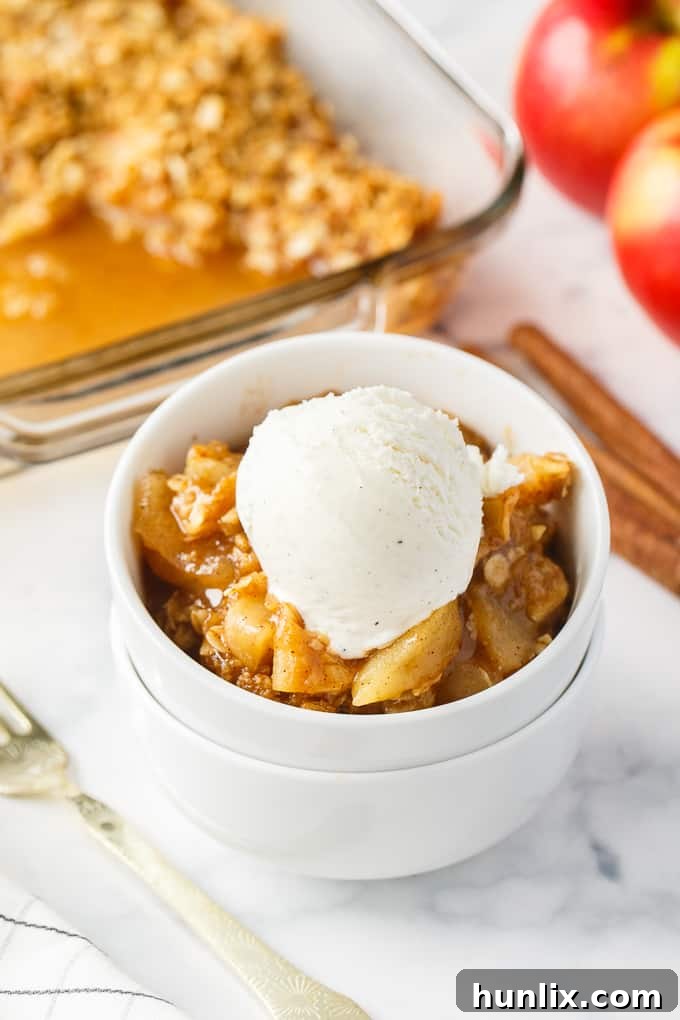 Apple Crisp - This simple old-fashioned dessert is baked with sweet and tart apples and topped with a brown sugar oat crumble. One of the best homemade fall desserts. Serve with vanilla ice cream for extra decadence.