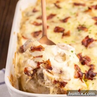 Creamy Chicken Pierogi Bake 9 Chicken Alfredo Pierogi Casserole - A hearty, baked dish featuring frozen pierogies, chicken, bacon, Alfredo sauce, onions, and mushrooms.