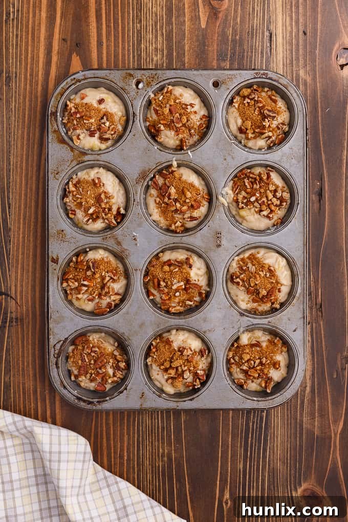 Freshly baked Banana Streusel Muffins cooling on a wire rack, with golden-brown tops.