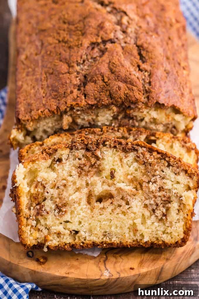 A slice of moist Cinnamon Bread with visible cinnamon swirls
