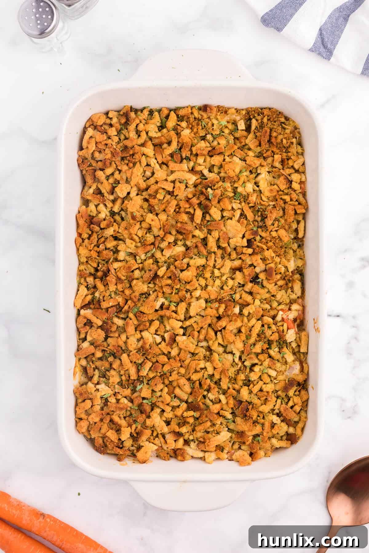 Sweet Carrot Bake 6 A close-up of the delicious and comforting Carrot Casserole, showcasing its creamy texture, melted cheese, and golden-brown stuffing topping.