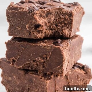 A stack of chocolate cake batter fudge squares.
