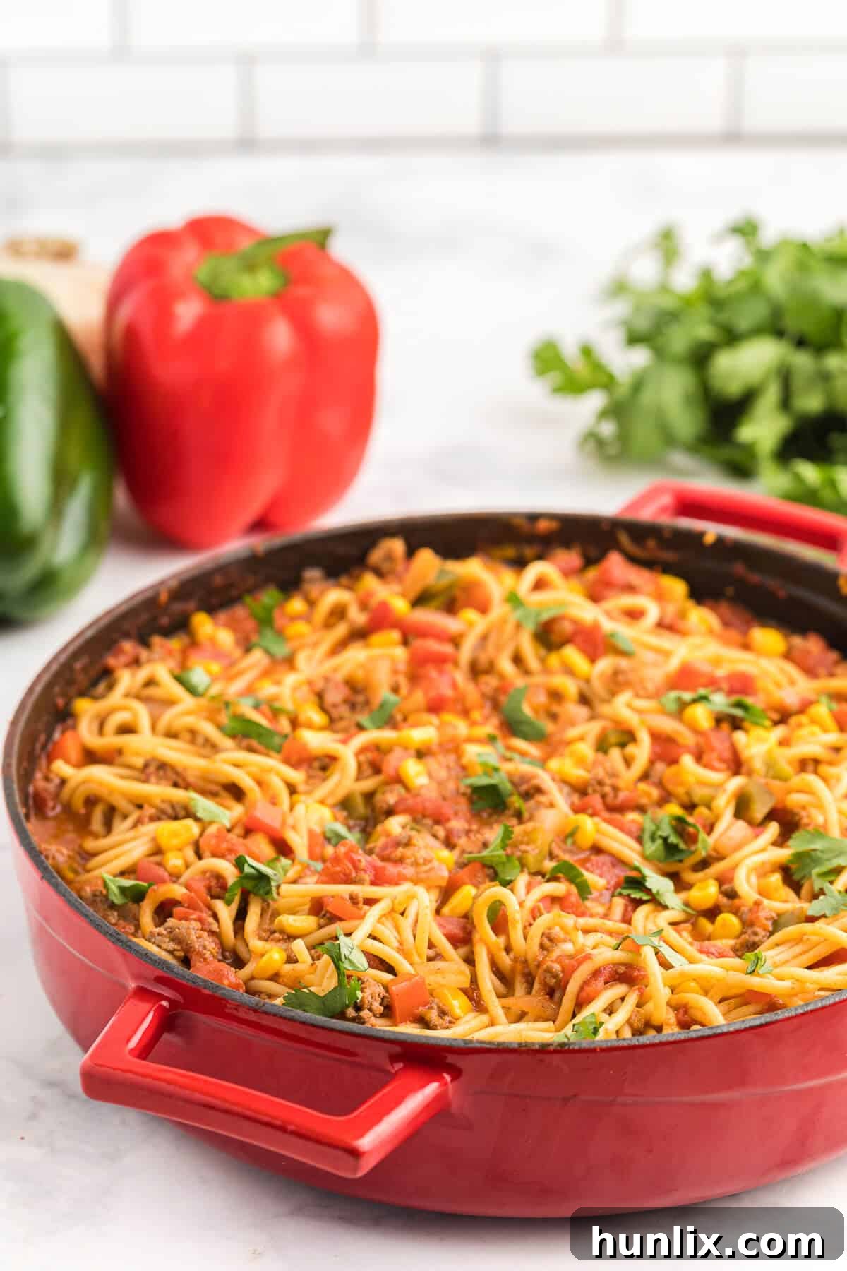 The Mexican spaghetti recipe presented in a vibrant red pan, ready to be served.