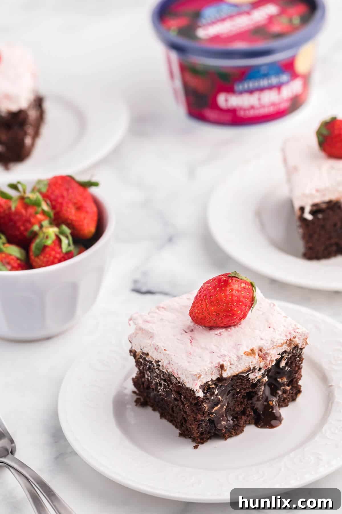 Decadent Strawberry and Chocolate Poke Cake with rich sauce and topping