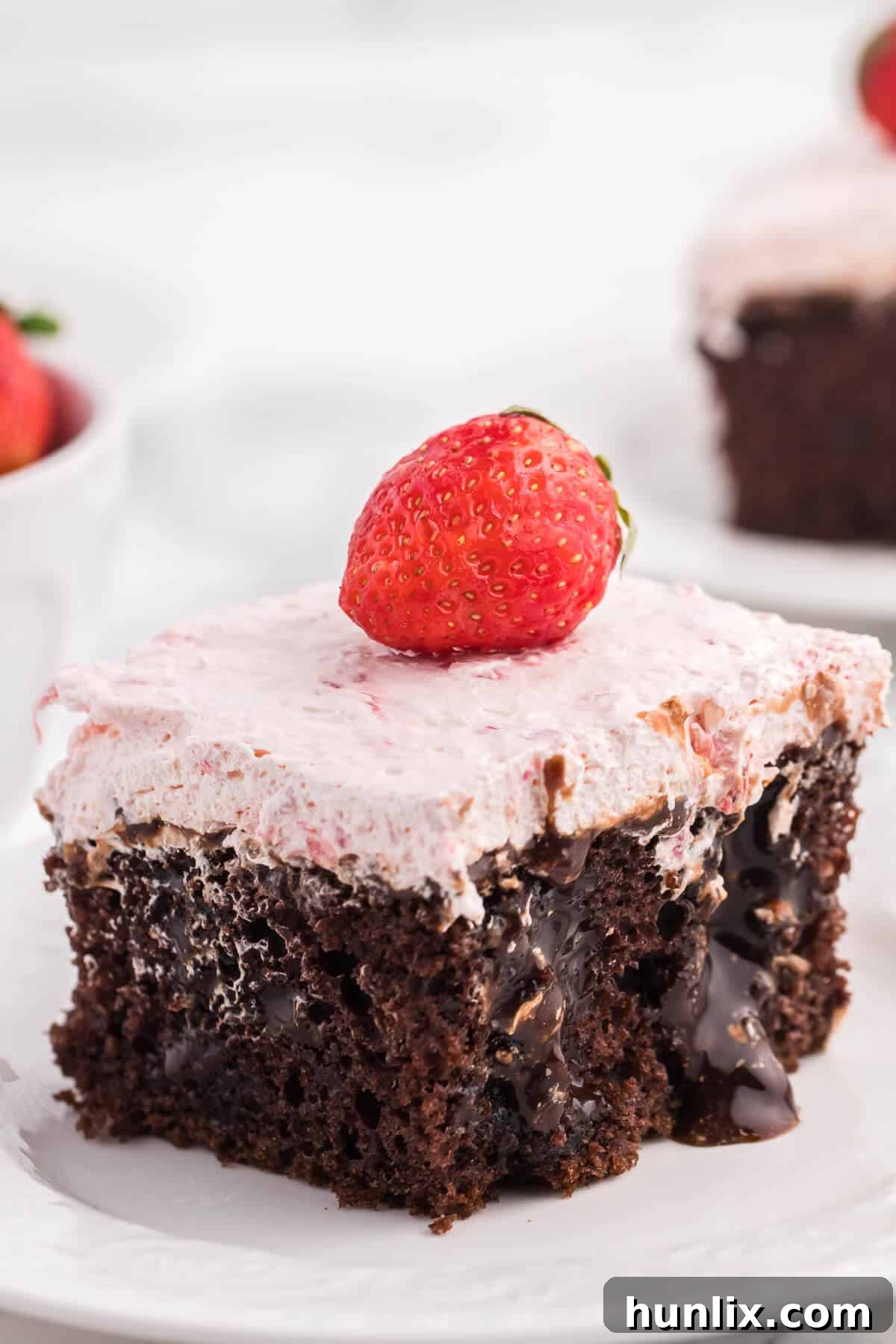 Close-up of Strawberry and Chocolate Poke Cake showing the infused chocolate sauce