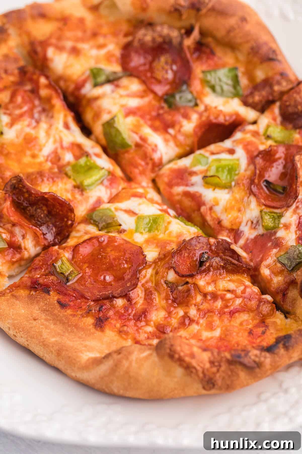 A delicious air fryer pizza on a plate, ready to be served, showcasing its golden crust and vibrant toppings.