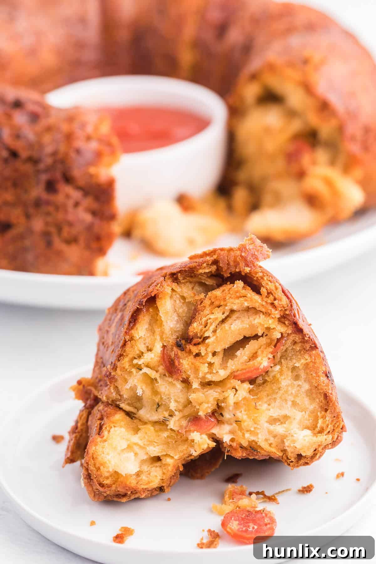 Pizza Monkey Bread with dipping sauce in the center, ready to eat