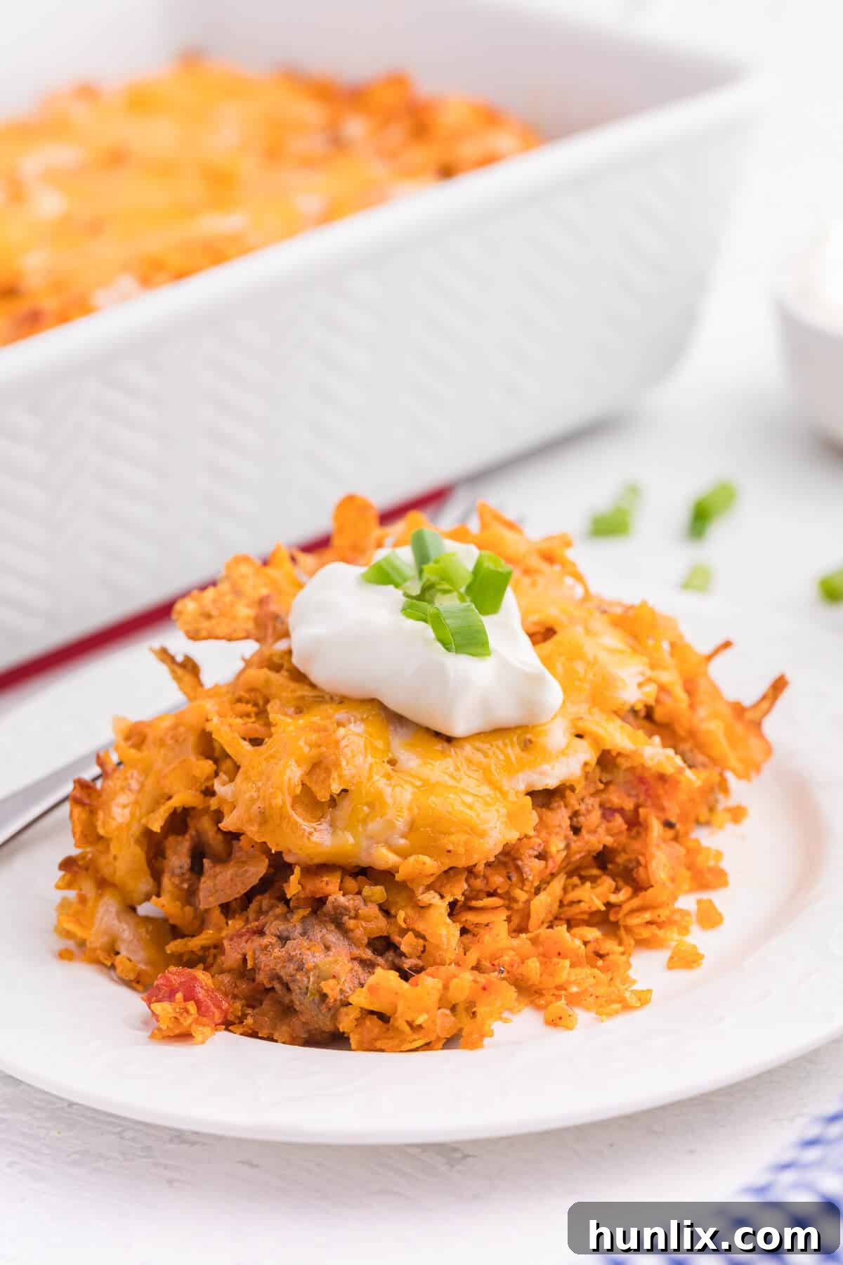 Loaded Doritos Casserole 2 Doritos Casserole Recipe - Take Mexican night to a whole new level with this easy taco bake recipe. Made with ground beef, sour cream, spices and loads of cheese, it's zesty with hearty Tex Mex flavor. A yummy dinner recipe your family will love!