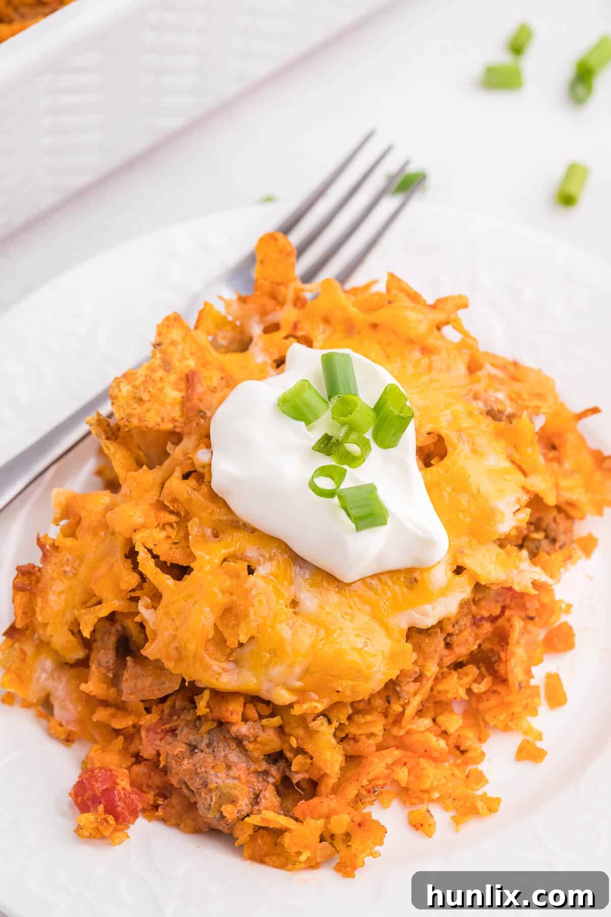 Loaded Doritos Casserole 11 Doritos Casserole Recipe - Take Mexican night to a whole new level with this easy taco bake recipe. Made with ground beef, sour cream, spices and loads of cheese, it's zesty with hearty Tex Mex flavor. A yummy dinner recipe your family will love!