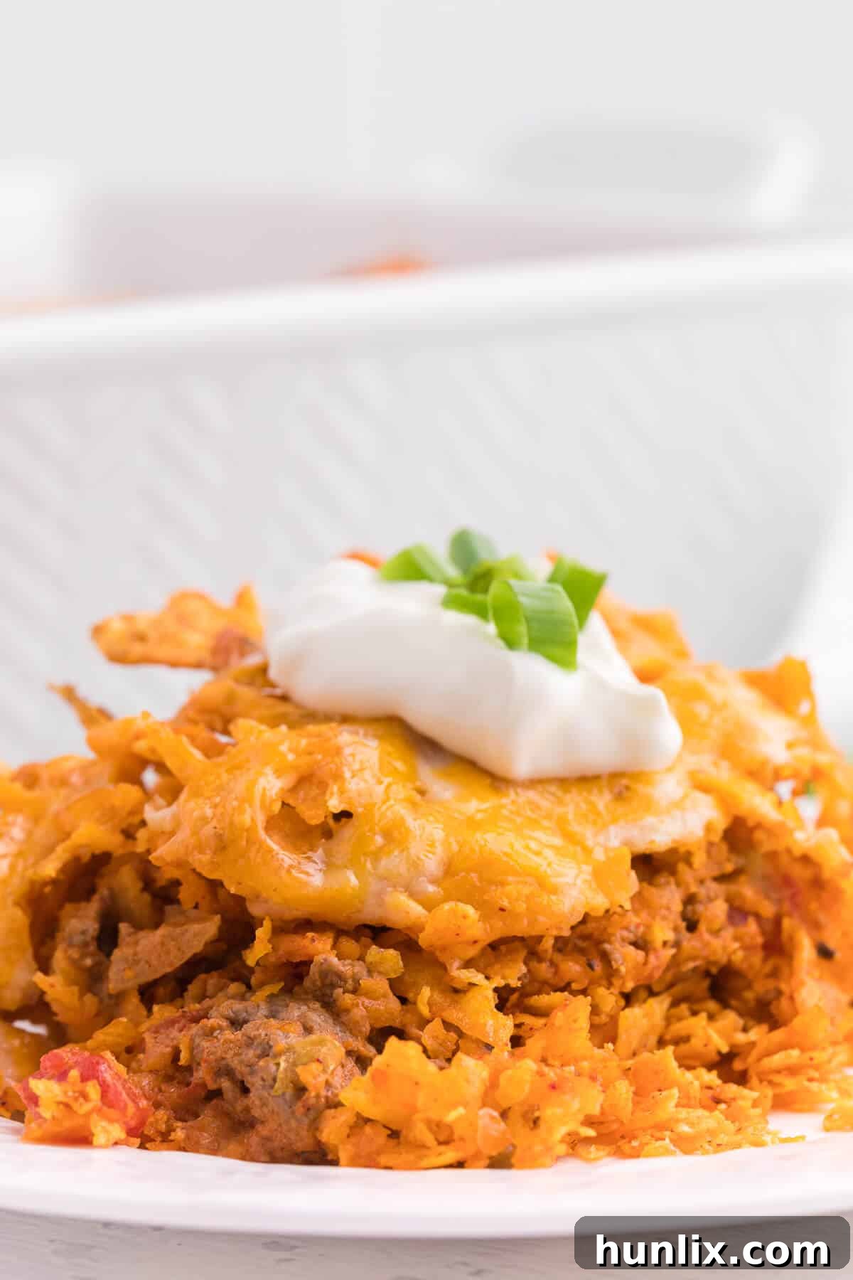 Loaded Doritos Casserole 12 Doritos Casserole Recipe - Take Mexican night to a whole new level with this easy taco bake recipe. Made with ground beef, sour cream, spices and loads of cheese, it's zesty with hearty Tex Mex flavor. A yummy dinner recipe your family will love!