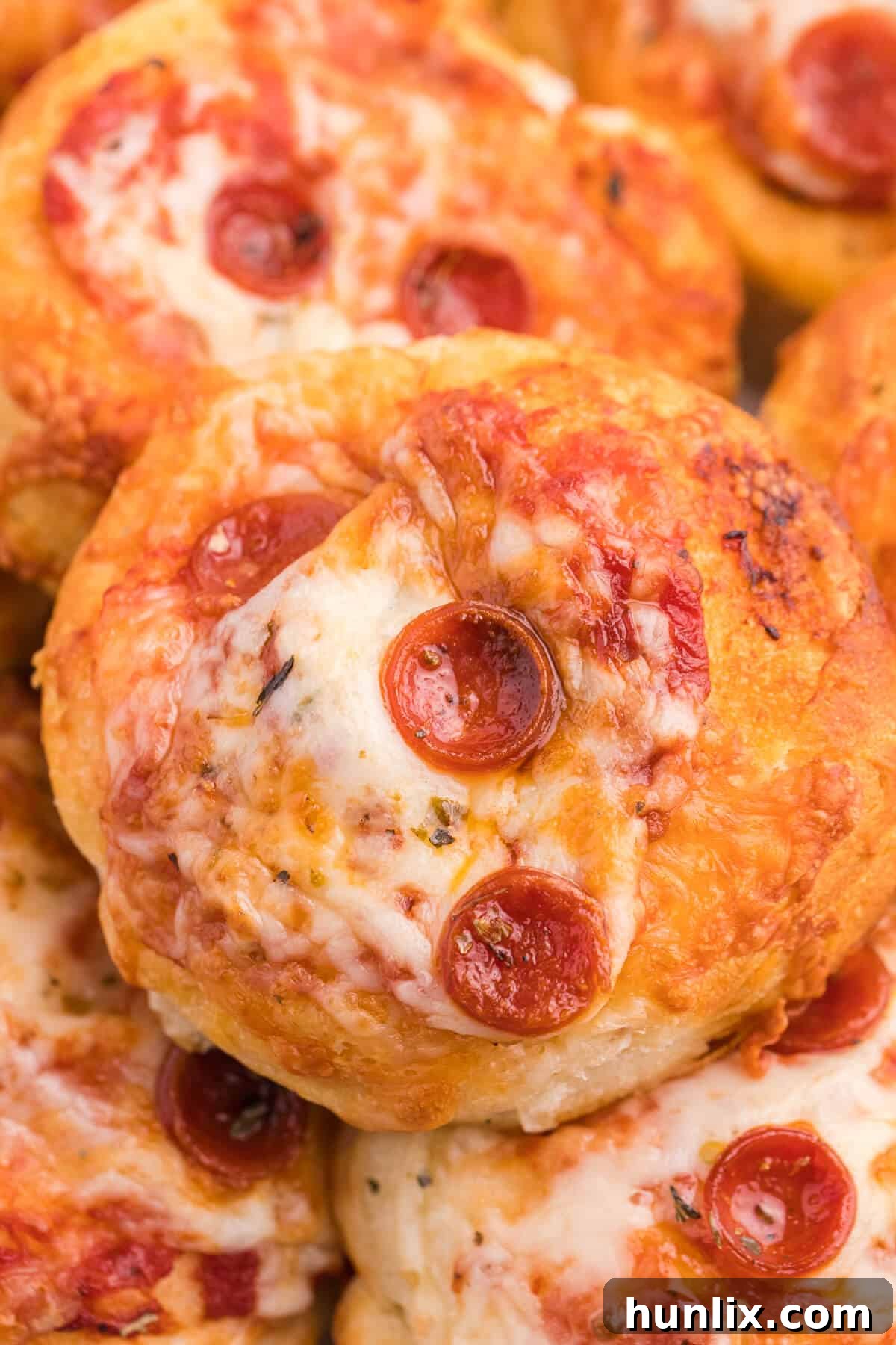Irresistible Air Fryer Pizza Buns 2 Close up of air fryer pizza buns, golden and cheesy.