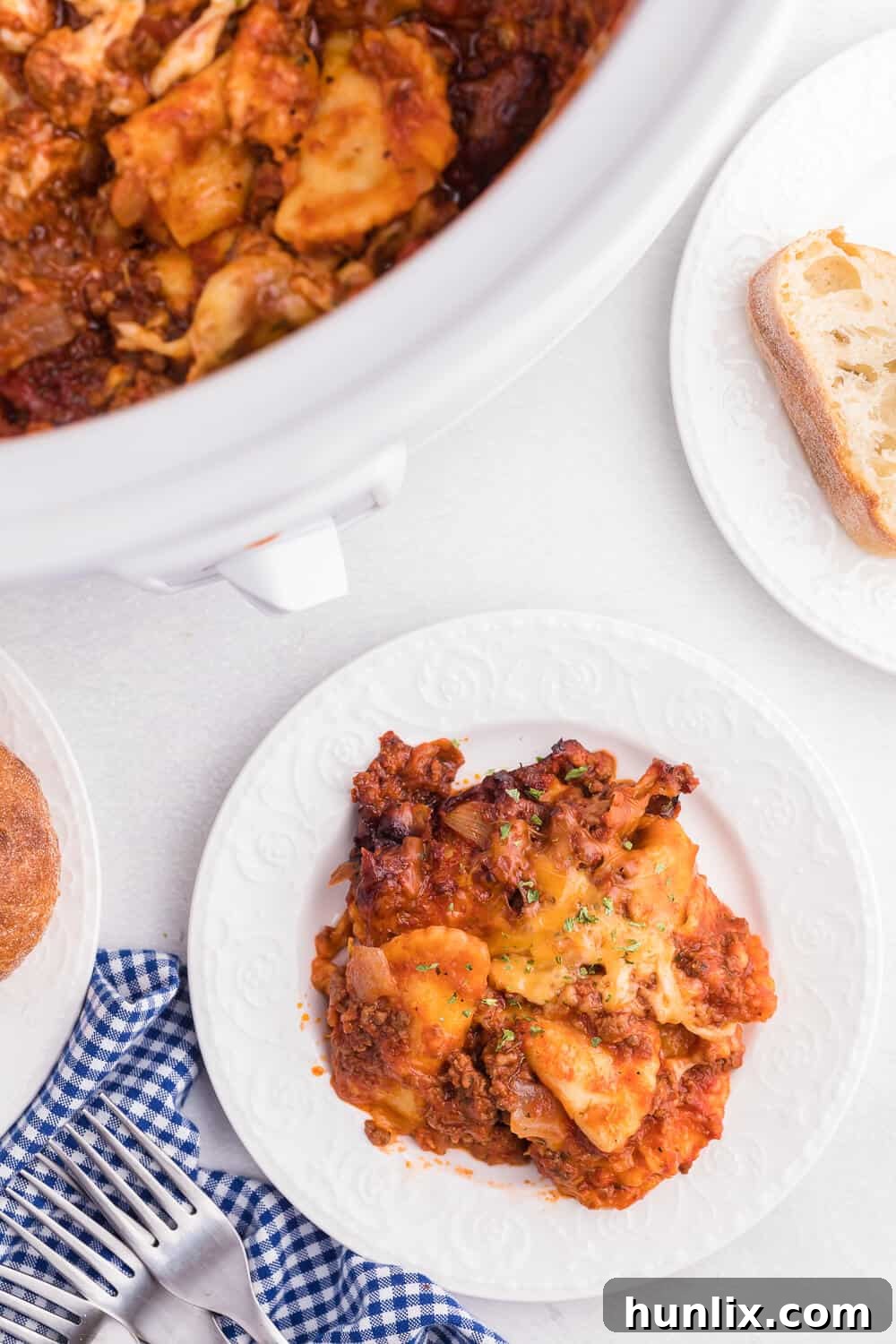 Easy One-Pot Slow Cooker Ravioli Lasagna 10 Slow Cooker Ravioli Lasagna - This Lazy Lasagna is a super easy Crockpot recipe made with frozen ravioli, homemade tomato sauce with beef and loads of cheese. You'll love all the cheesy, hearty layers. Plus, it's freezer friendly!