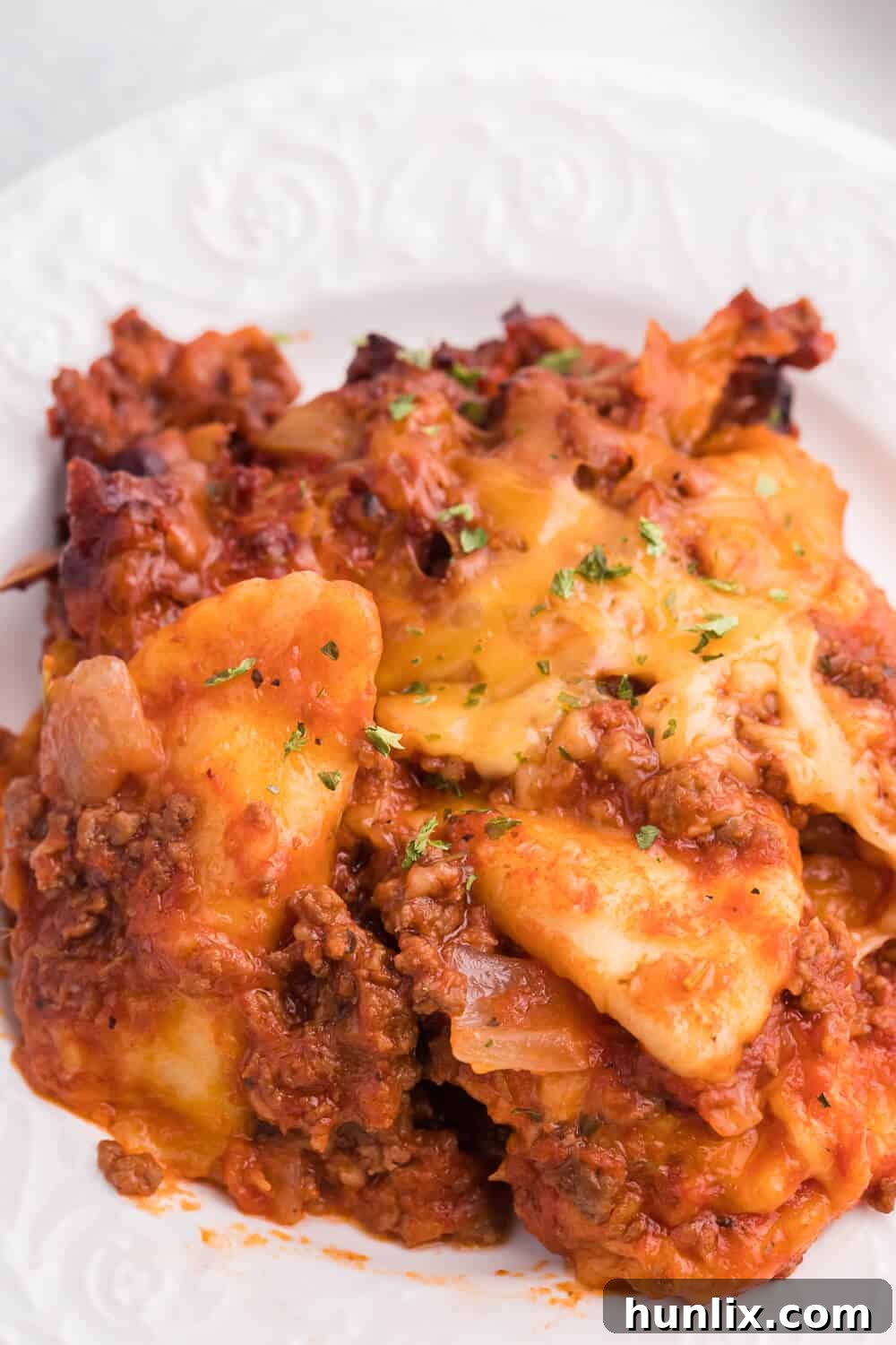 Easy One-Pot Slow Cooker Ravioli Lasagna 9 Slow Cooker Ravioli Lasagna - This Lazy Lasagna is a super easy Crockpot recipe made with frozen ravioli, homemade tomato sauce with beef and loads of cheese. You'll love all the cheesy, hearty layers. Plus, it's freezer friendly!