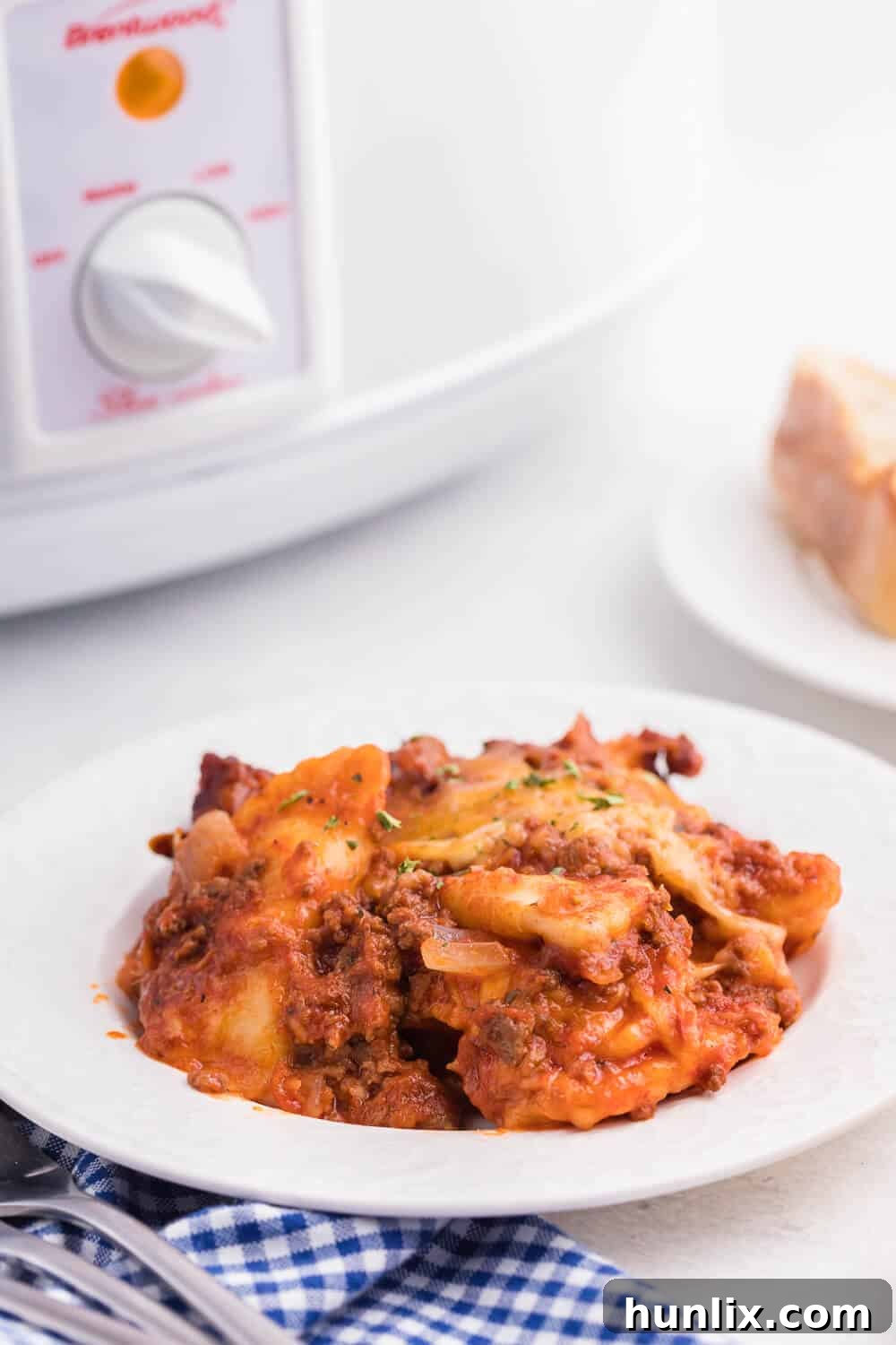Easy One-Pot Slow Cooker Ravioli Lasagna 12 Slow Cooker Ravioli Lasagna - This Lazy Lasagna is a super easy Crockpot recipe made with frozen ravioli, homemade tomato sauce with beef and loads of cheese. You'll love all the cheesy, hearty layers. Plus, it's freezer friendly!