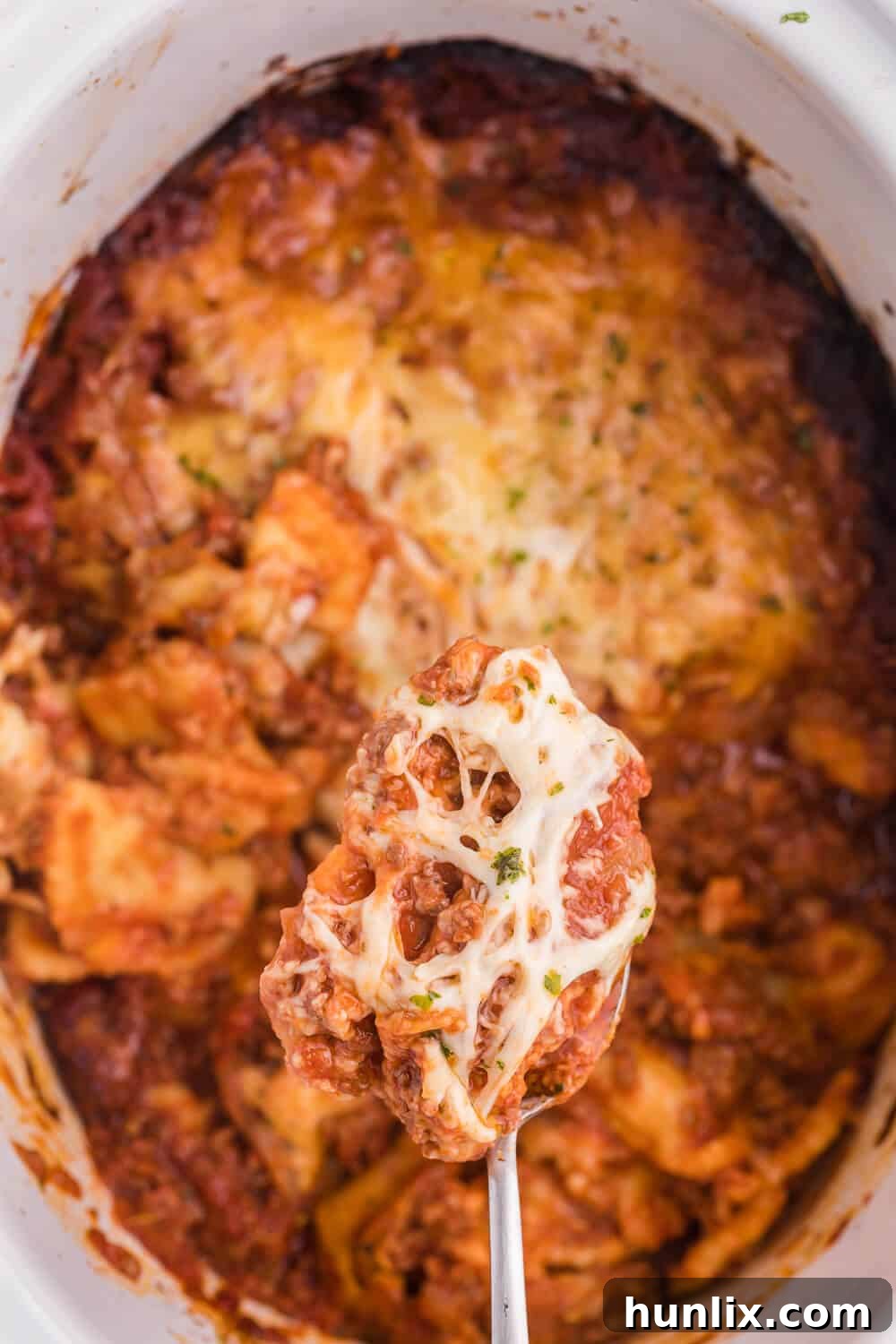 Easy One-Pot Slow Cooker Ravioli Lasagna 8 Slow Cooker Ravioli Lasagna - This Lazy Lasagna is a super easy Crockpot recipe made with frozen ravioli, homemade tomato sauce with beef and loads of cheese. You'll love all the cheesy, hearty layers. Plus, it's freezer friendly!