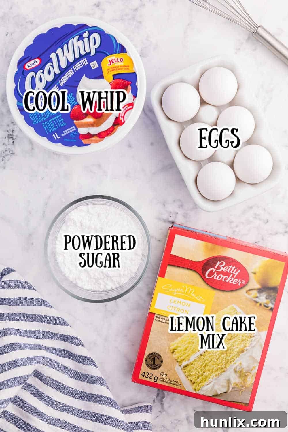 Close-up of the four simple ingredients needed for Cool Whip Cookies: a box of cake mix, a tub of Cool Whip, an egg, and a bowl of powdered sugar.