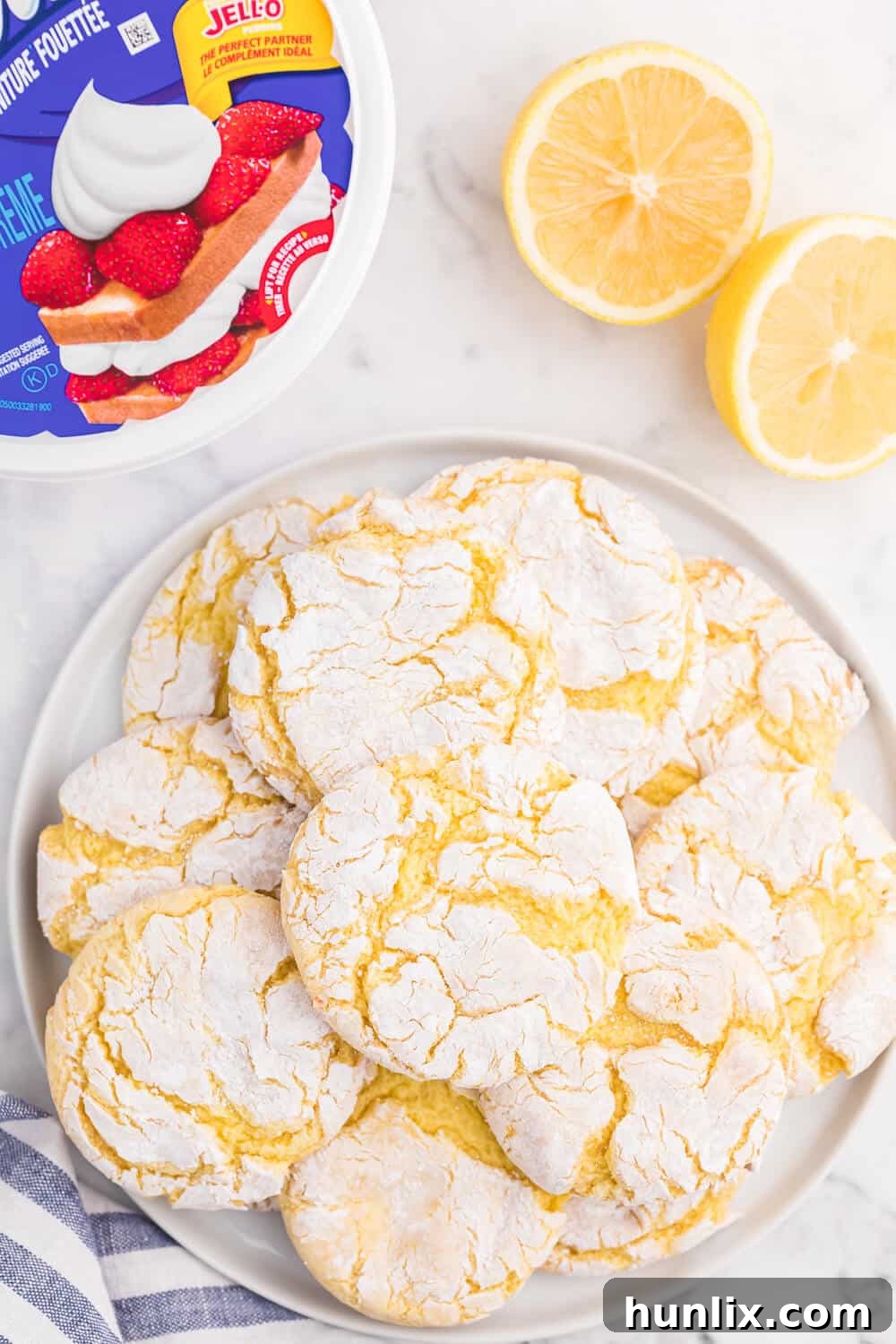 A stack of golden brown Cool Whip Cookies, powdered sugar coating visible, ready for serving or storage.
