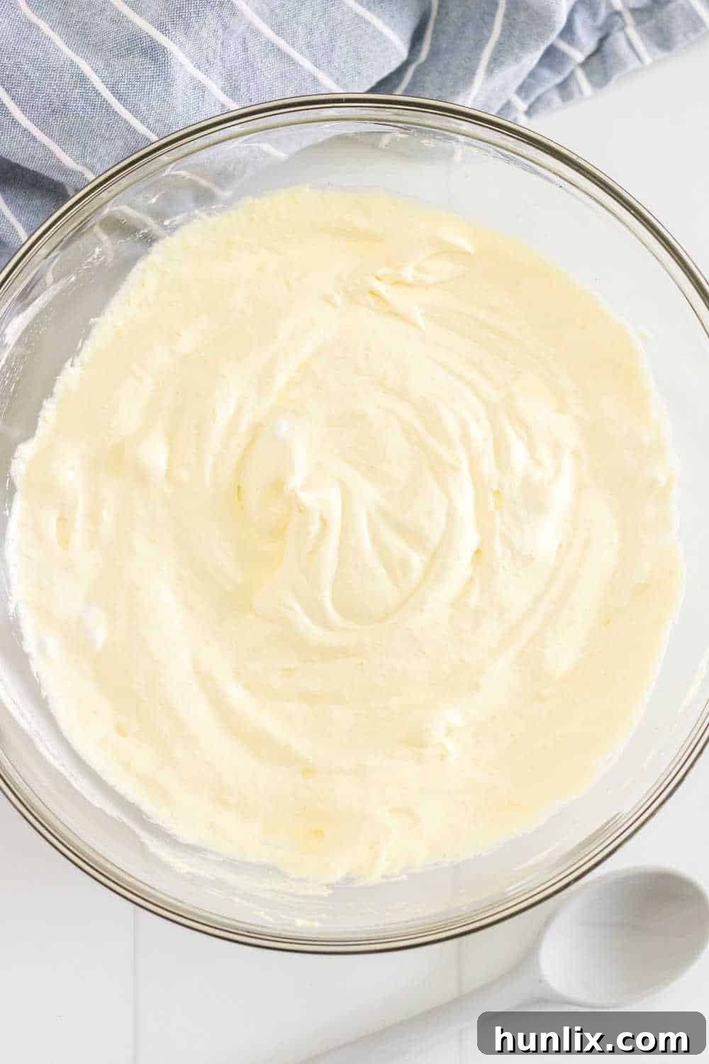 Creamy Caramel Snickers Apple Salad 4 Vanilla pudding mix and milk are stirred together in a large bowl, followed by gently folding in thawed Cool Whip to create a smooth, creamy base.