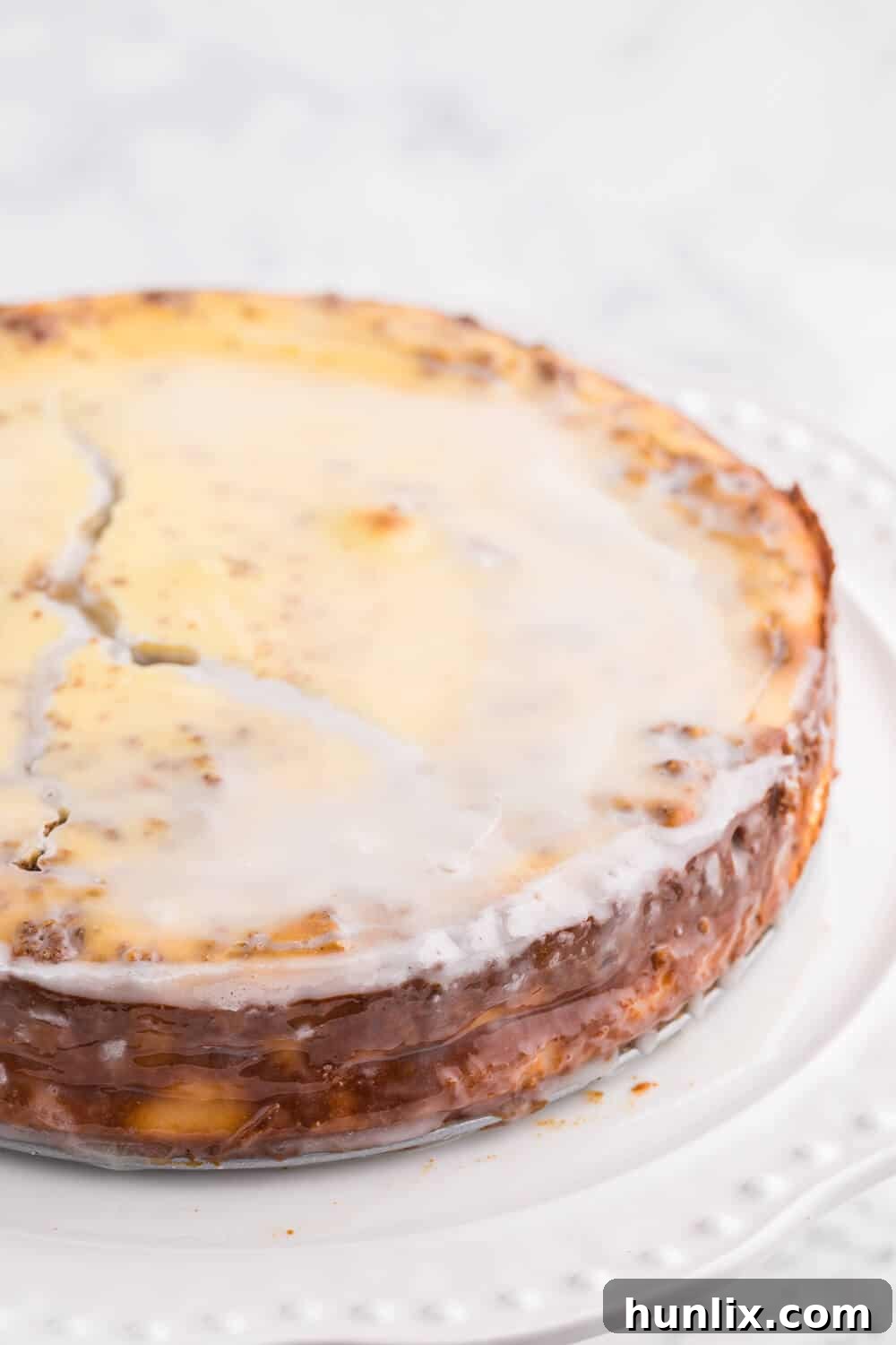 Decadent Cinnamon Roll Cheesecake Recipe on a pristine white platter, ready to be served.