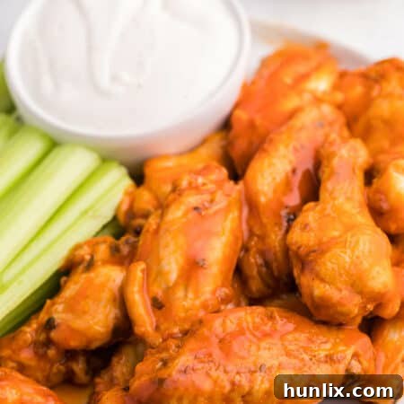 The recipe on a plate with celery sticks and ranch dip.