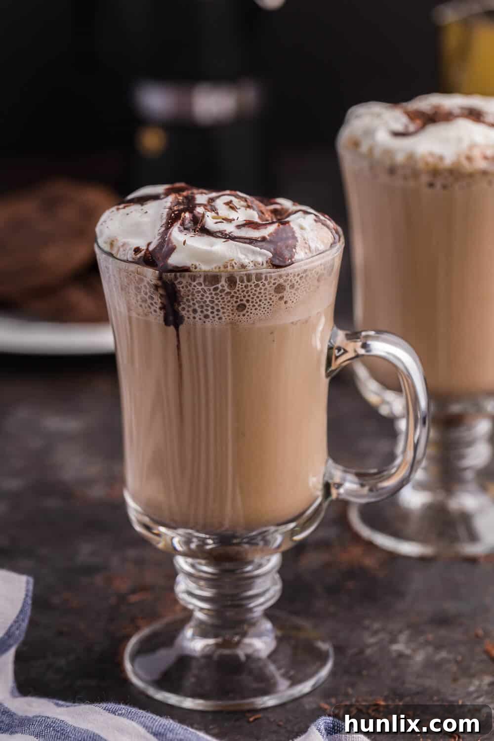 A glass mug of the finished mocha latte, highlighting its rich color and creamy texture.