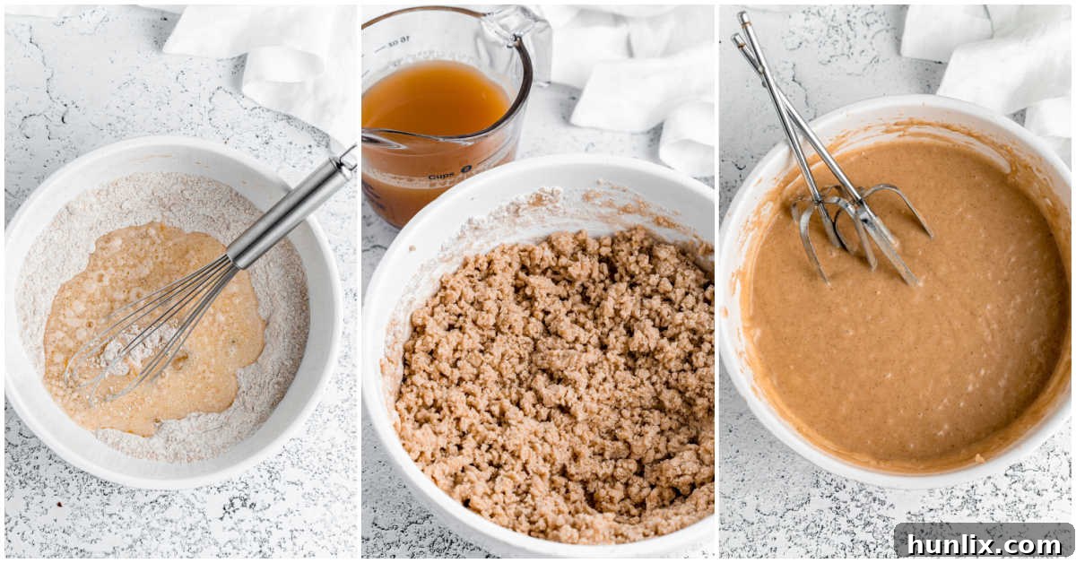 A hand mixer blending wet and dry ingredients in a bowl, creating a smooth, light-brown batter for apple cider donuts, illustrating the batter's consistency.