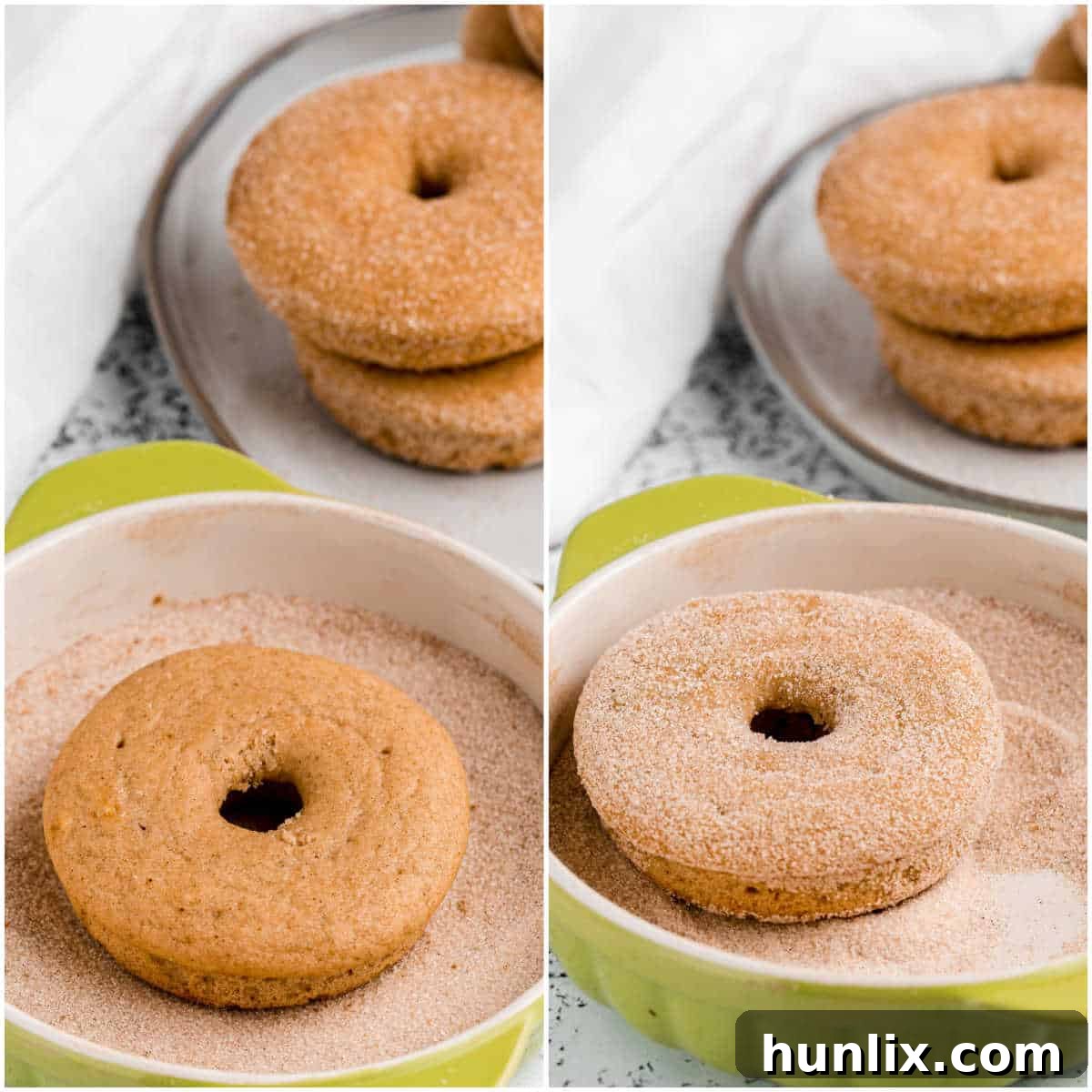 A baked apple cider donut being carefully dipped and coated in a bowl of cinnamon sugar, showing the sweet, spiced crust forming on its surface.