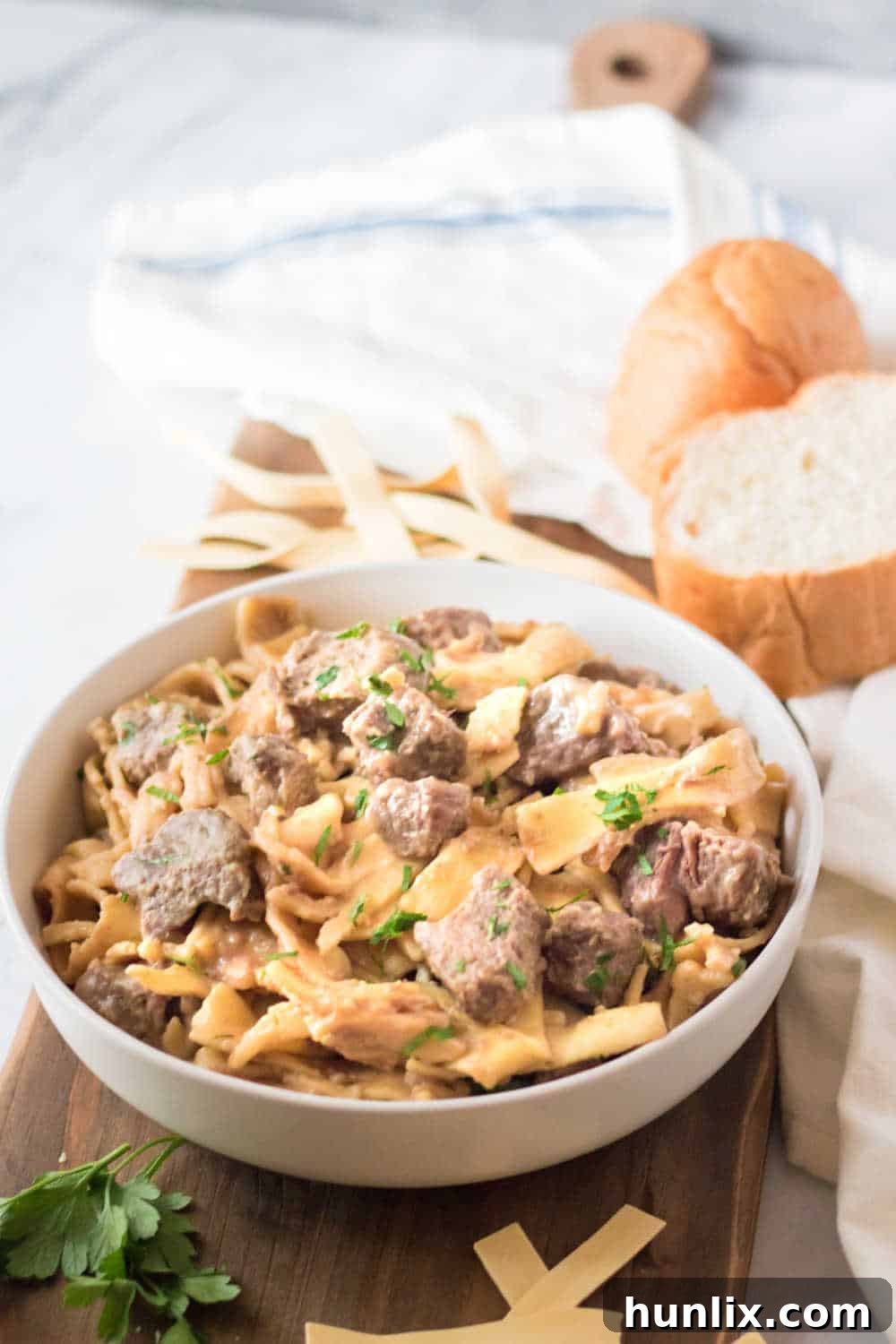 A rustic bowl filled with slow cooker beef and noodles, ready to be enjoyed.