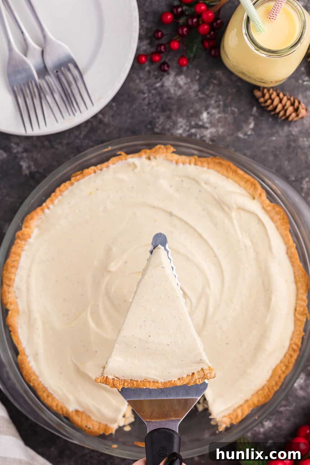 A perfect slice of eggnog pie being lifted with a spatula, ready to be served.