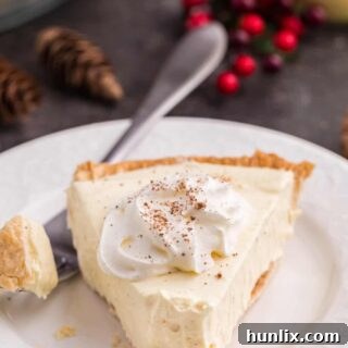 A slice of eggnog pie on a plate with a fork.