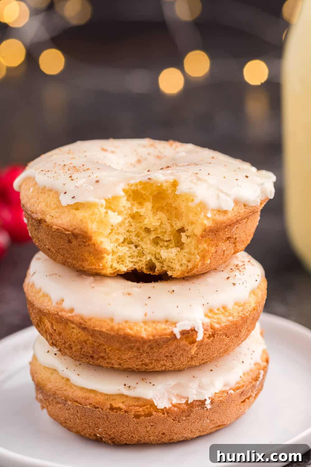 Eggnog donuts stacked on a plate