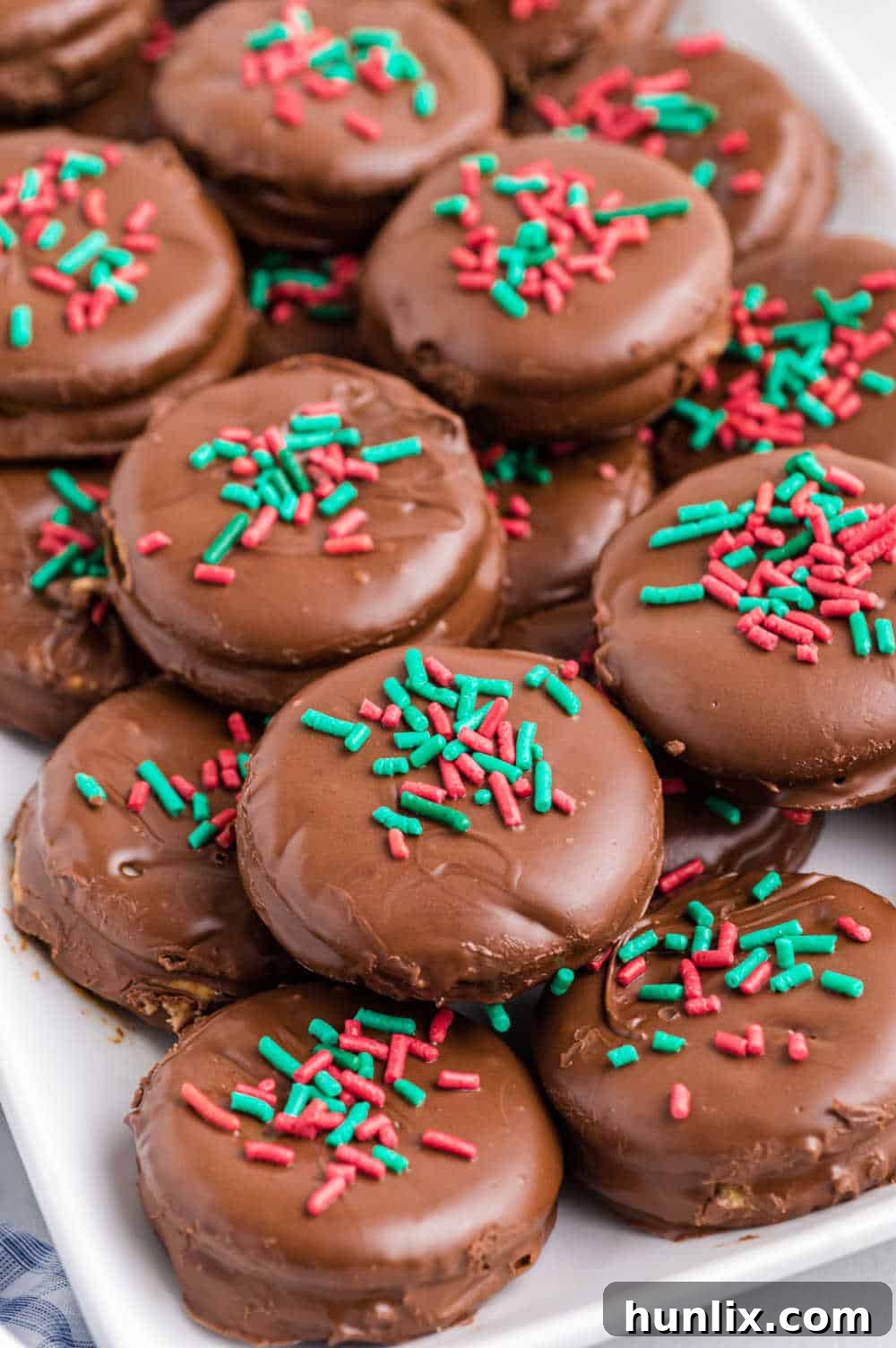 Ritz Cracker Delights 2 A festive platter of golden-brown Ritz Cracker Cookies, glistening with chocolate and sprinkles.