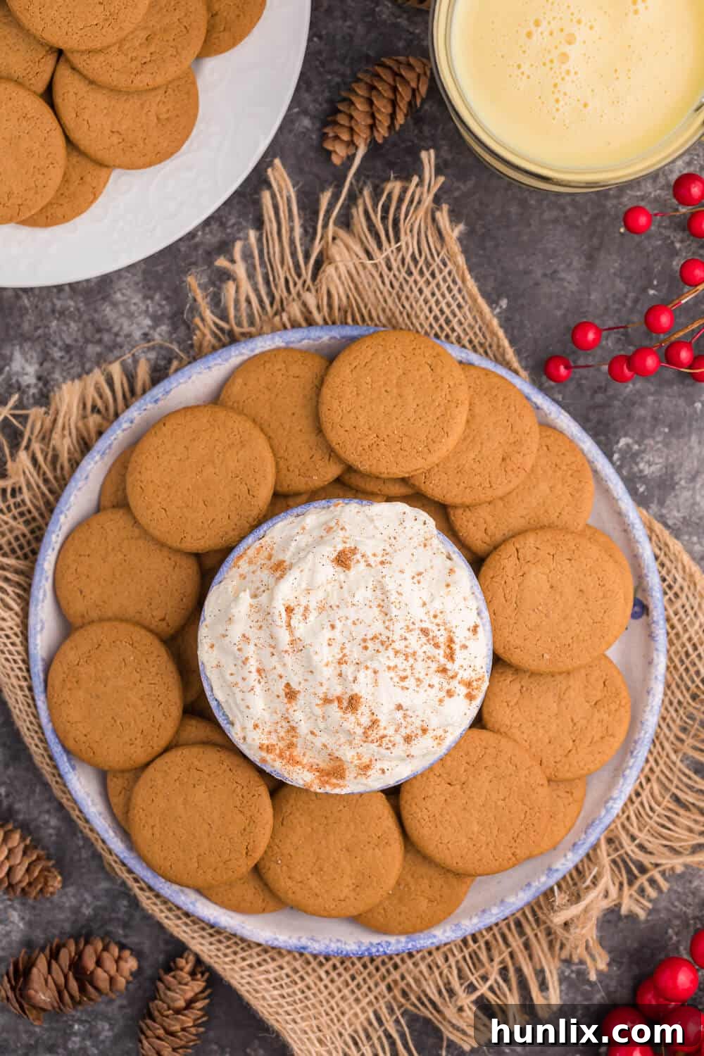 Creamy Eggnog Dip surrounded by festive gingersnap cookies, perfect for Christmas gatherings.
