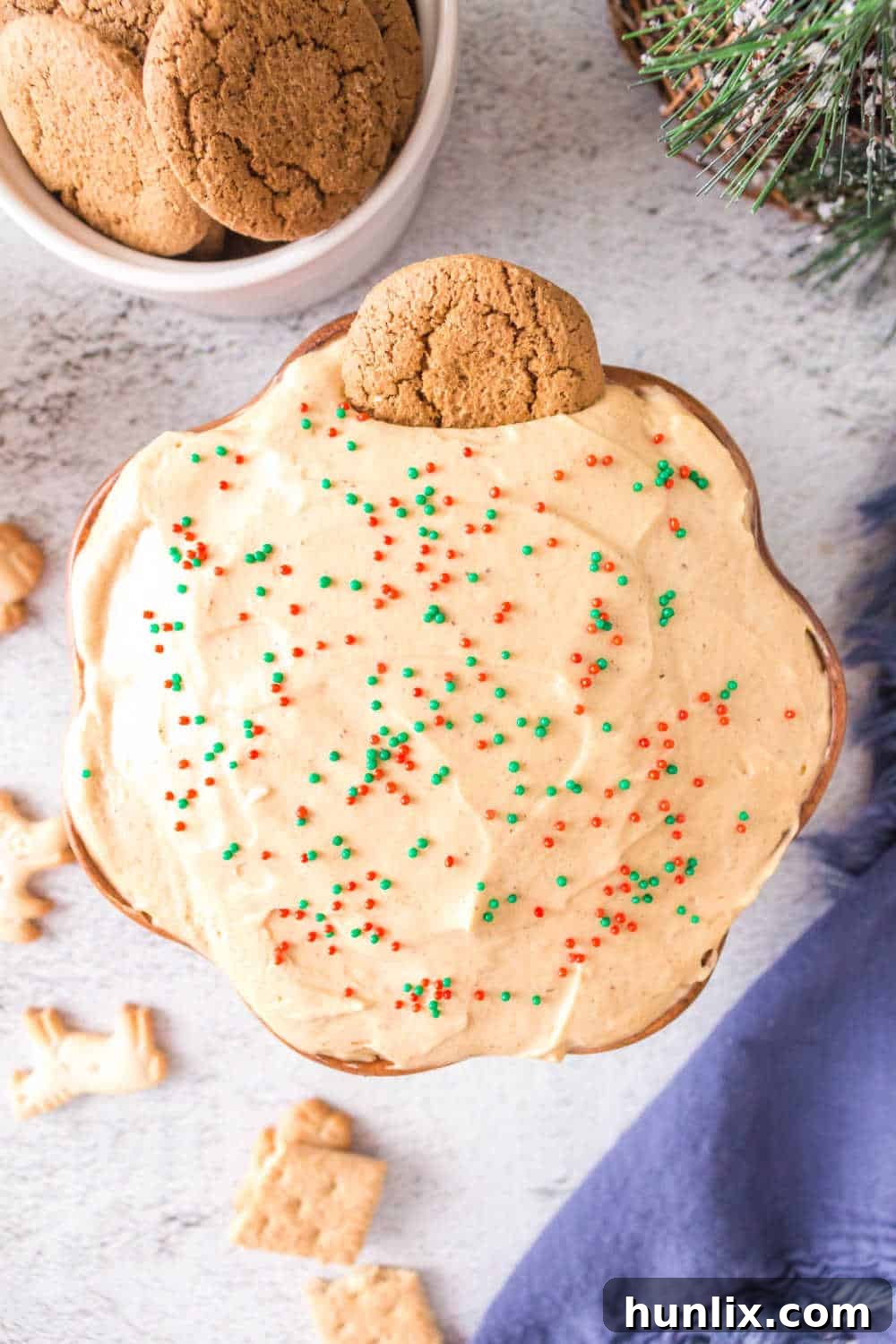 Spiced Gingerbread Delight 2 A bowl of creamy gingerbread dip with a ginger snap cookie resting in it, ready for dipping.