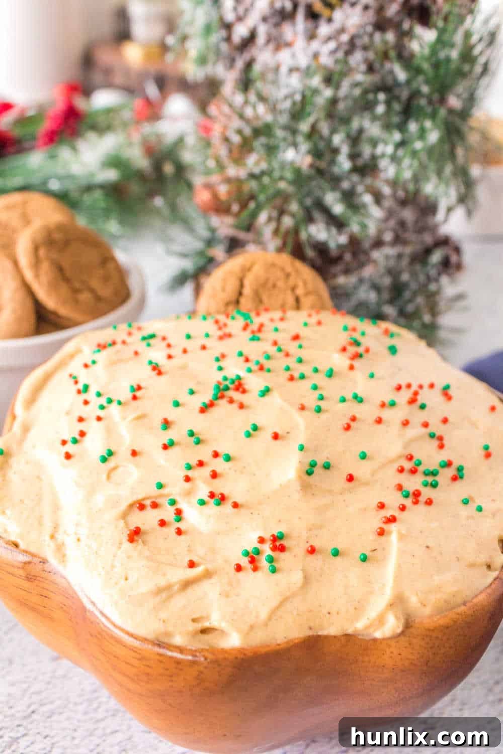 Spiced Gingerbread Delight 6 A beautifully presented gingerbread dip in a wooden bowl, garnished with a whole cinnamon stick and star anise, ready for serving.