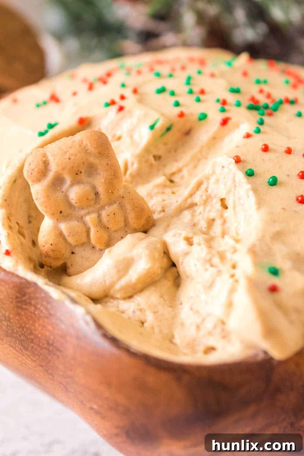 Spiced Gingerbread Delight 9 A bowl of gingerbread dip with an animal cracker gently dipped into it.
