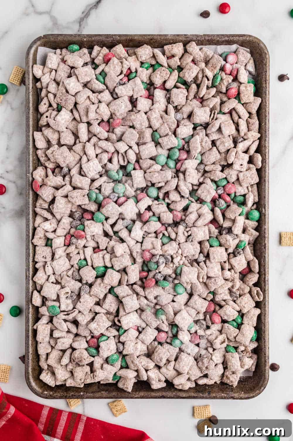 Reindeer chow on a baking sheet, showcasing its festive colors and textures.