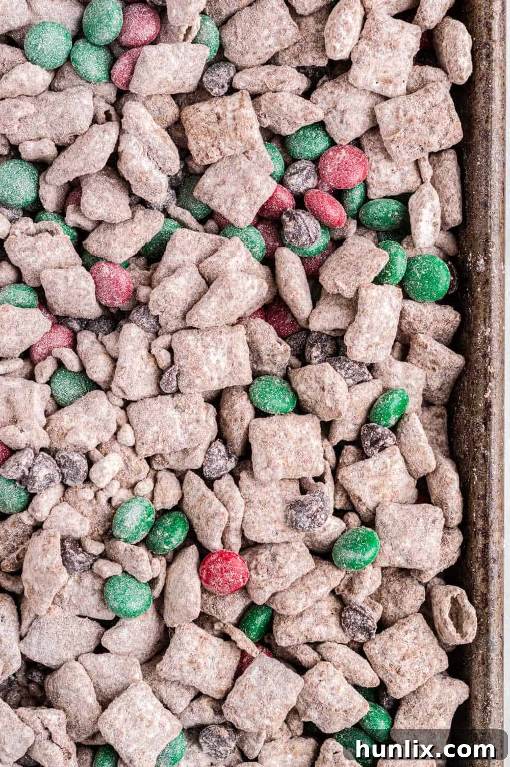 The completed Reindeer Chow recipe spread out on a baking sheet, ready to be served or gifted.